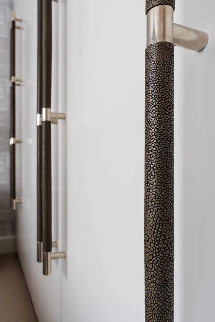 Large multi grip door pulls made by Turnstyle Designs. These pulls are placed on tall cupboard doors in a master bedroom